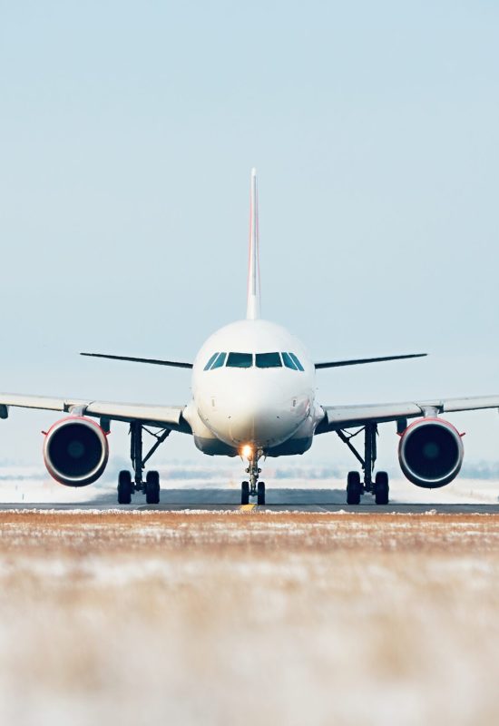Airport in winter. Airplane taxiing to the runway for take off.